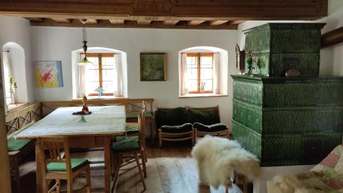 a living room with a table and chairs and a dog at Naturparadies am Sonntagberg in Sonntagberg