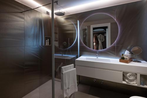 a bathroom with a sink and a mirror at Savoy Beach Hotel & Thermal Spa in Bibione