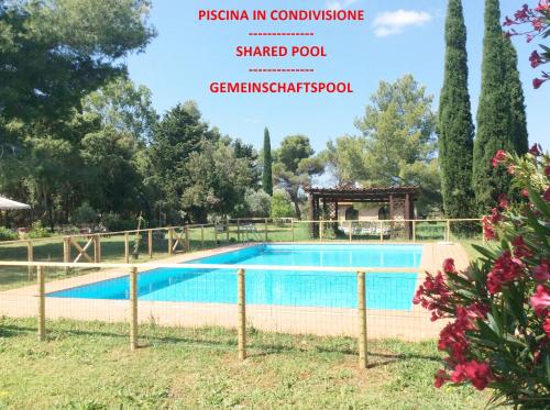 a villa with a swimming pool in a resort with a garden at Relais Casale Il Poggetto - OLEANDRI in Cecina