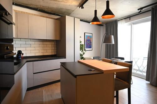 a kitchen with a kitchen island in a room at New & unique apartment - Your home away from home in Taʼ Xbiex