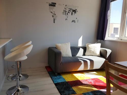 a living room with a couch and a chair at CEU Konferencia Központ in Budapest