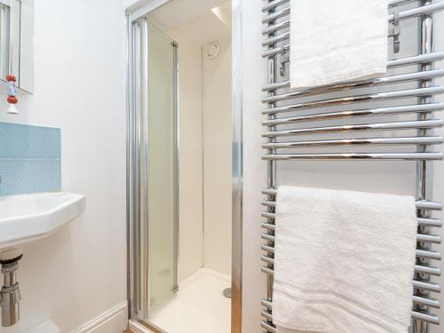 a bathroom with a towel rack next to a shower at Pass the Keys Spacious family home with parking in Bath