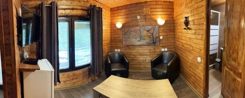 a room with chairs and a table in a train at Complex Vila Balea in Cumpăna