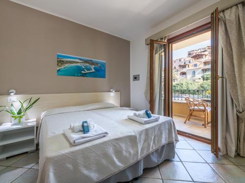 a bedroom with a bed and a balcony at B&B Simius Bay in Villasimius