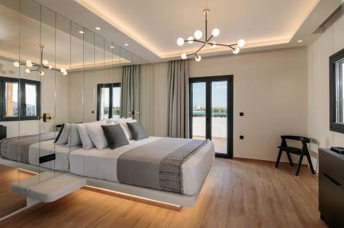 1 dormitorio con 1 cama grande y espejo grande en Iphimedeia Luxury Hotel & Suites en Naxos