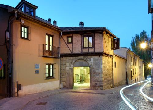 
a building with a clock on the side of it at Exe Casa de Los Linajes in Segovia
