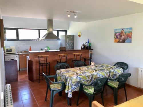 uma cozinha e sala de jantar com mesa e cadeiras em Los Robles-PLAYA COROSO em Ribeira