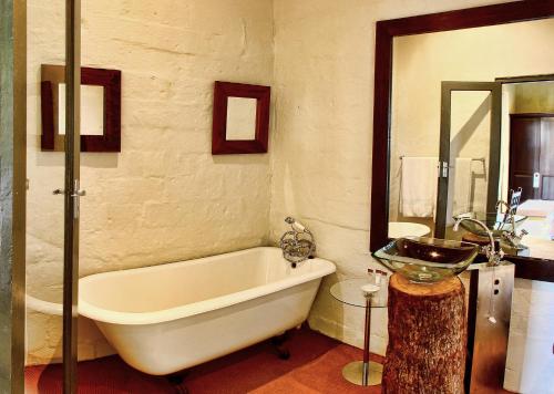 a bathroom with a bath tub and a sink at Tala Collection Game Reserve in Silverton