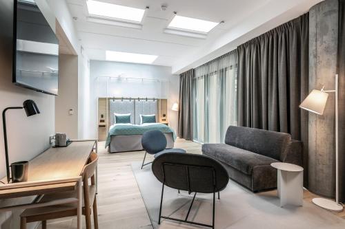 a living room with a bed and a couch at Quality Hotel Hasle Linie in Oslo