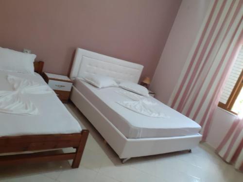 a bedroom with two beds and a window at Orikum beach in Orikum