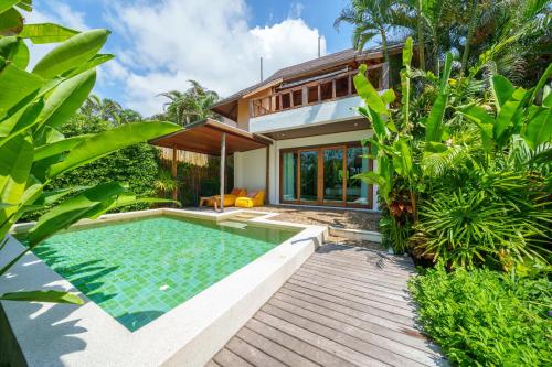 a villa with a swimming pool and a house at Tinkerbell Resort @ Koh Kood in Ko Kood