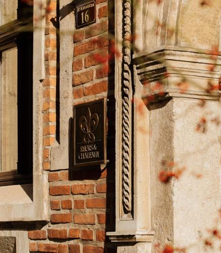 a sign on the side of a brick building at Hotel Copernicus in Kraków