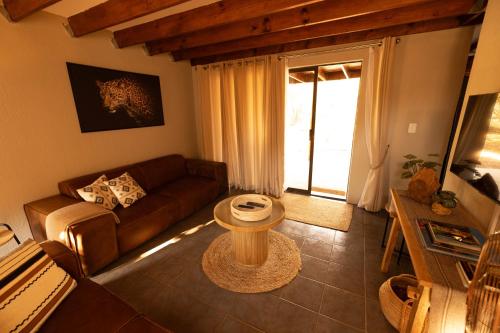 a living room with a couch and a table at Bushveld Jewel - Close to Kruger in Hoedspruit