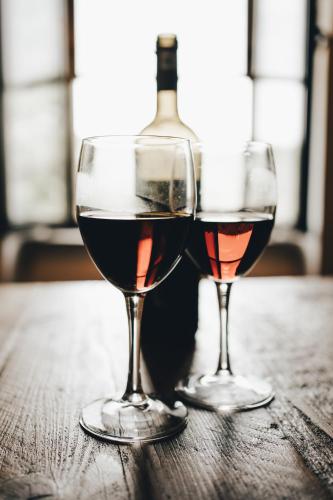 two glasses of red wine sitting on a wooden table at Antica Porta di Sovana 2.0 in Pitigliano