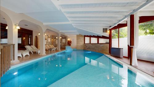 a large swimming pool in a house at Acrotel Athena Pallas in Elia