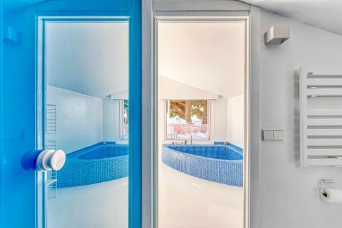 a bathroom with a swimming pool through a glass door at The Pink Elephant Hotel in Sant Feliu de Guixols