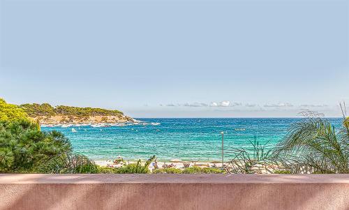 a view of a beach with the ocean in the background at The Pink Elephant Hotel in S'Agaro