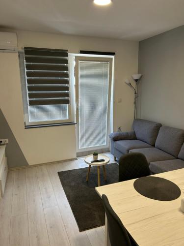 a living room with a couch and a table at Apartmani "Stari Grad - Samobor" in Samobor