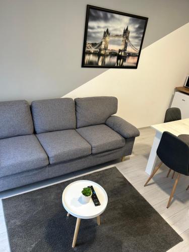 a living room with a couch and a table at Apartmani "Stari Grad - Samobor" in Samobor