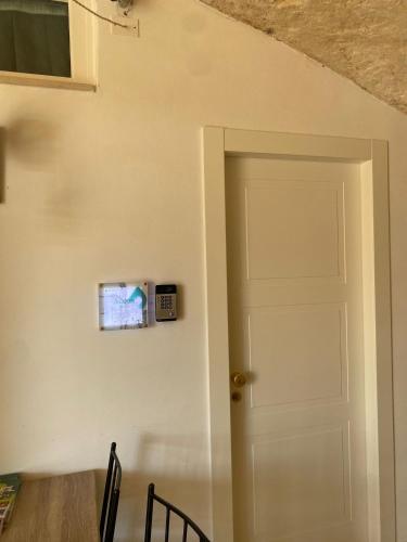an open door in a room with a table and chairs at 5 Elementi Sassi Matera in Matera