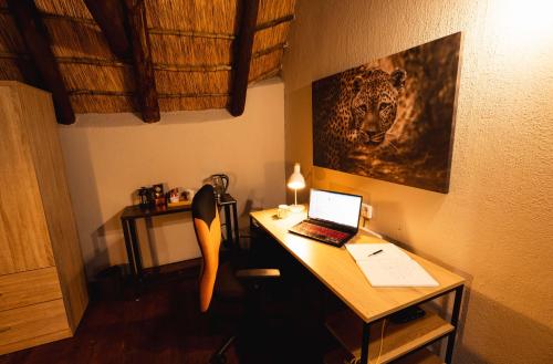 a desk with a laptop computer on top of it at Bushveld Jewel - Close to Kruger in Hoedspruit