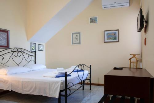 Ένα ή περισσότερα κρεβάτια σε δωμάτιο στο Villa Eleonora con piscina Fronte Mare