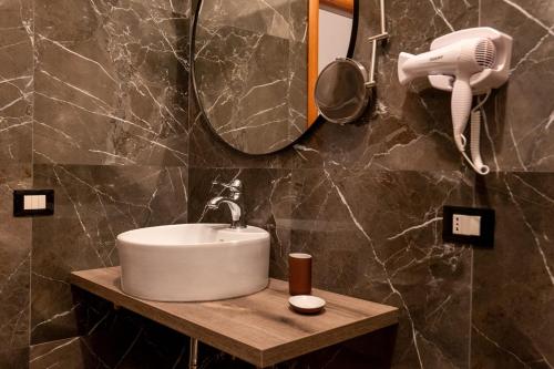 a bathroom with a sink and a hair dryer at Santé in Sannicandro Garganico