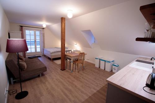a living room with a bed and a table at COUNTRY HOUSE Tisá in Tisá