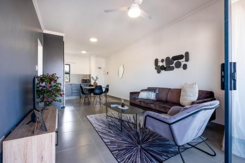 a living room with a couch and a table at Ballito Village Luxury Apartments in Ballito