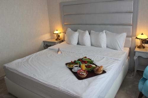a tray of food on a bed in a hotel room at Phoenicia Grand Hotel in Bucharest