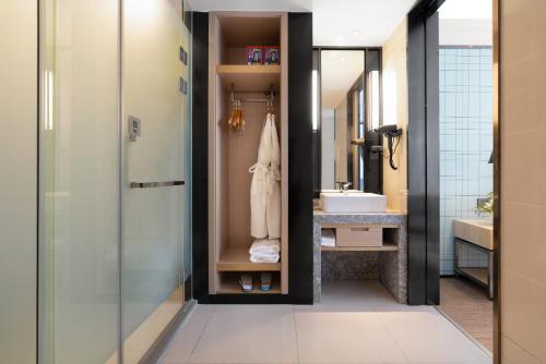 a bathroom with a shower and a sink at Echarm Hotel Xiamen Airport Hi-tech Park in Xiamen