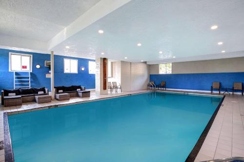 a large swimming pool in a hotel room at Days Inn by Wyndham Victoria Uptown in Victoria