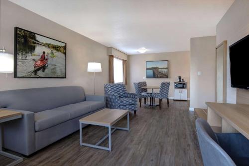 a living room with a couch and a table at Days Inn by Wyndham Victoria Uptown in Victoria