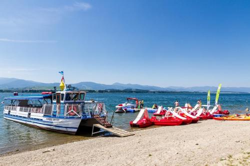 a group of boats are docked on a beach at Penzion Sankt Johann in Liptovský Ján