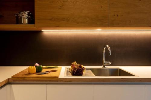 a kitchen counter with a sink and fruits and vegetables at Villa MaR-sea view,private pool in Orasac