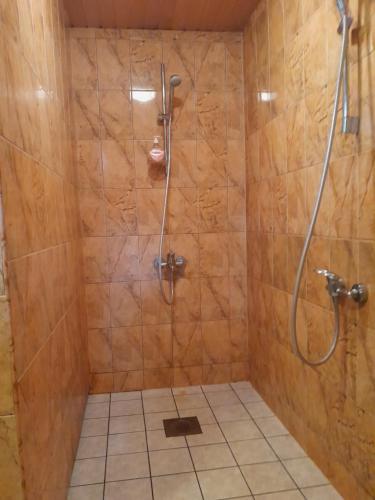 a bathroom with a shower with a glass door at Käbi Holiday Homes in Ainja
