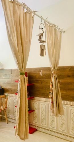 two curtains in a room with a table at Whispering Pines Dalat (Thông Thì Thầm ĐL) in Da Lat
