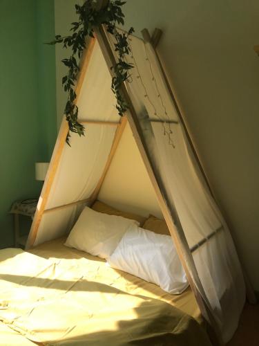 a bed with a canopy in a bedroom at Whispering Pines Dalat (Thông Thì Thầm ĐL) in Da Lat