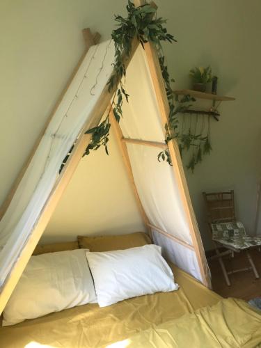 a bed in a room with a tent at Whispering Pines Dalat (Thông Thì Thầm ĐL) in Da Lat