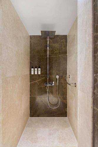 a bathroom with a shower with a shower head at Maxx Royal Belek Golf Resort in Belek