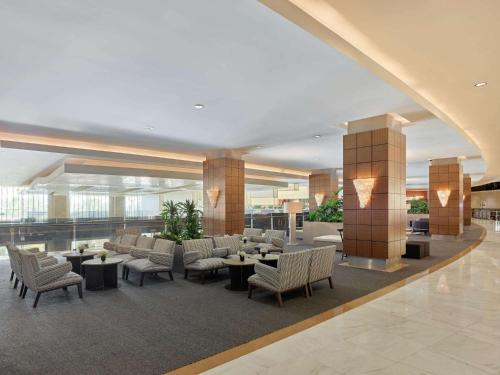 a lobby with chairs and tables in a building at Maxx Royal Belek Golf Resort in Belek
