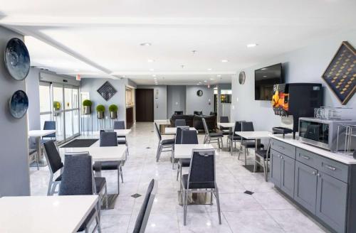 a dining room with tables and chairs and a cafeteria at Days Inn by Wyndham College Park Atlanta Airport South in Atlanta