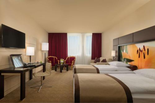 A bed or beds in a room at Lindner Hotel Vienna Am Belvedere, part of JdV by Hyatt