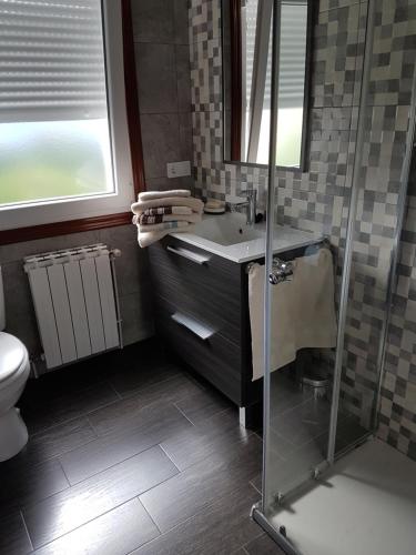 a bathroom with a sink and a shower at Casa Camiño dos Faros 