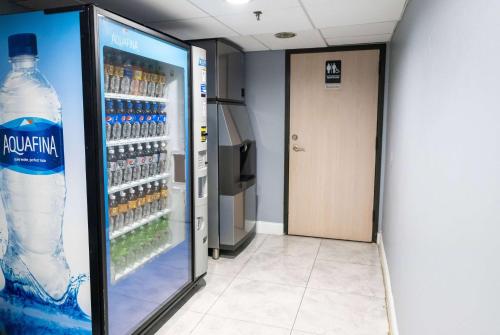 a refrigerator filled with lots of bottles of water at Days Inn by Wyndham College Park Atlanta Airport South in Atlanta