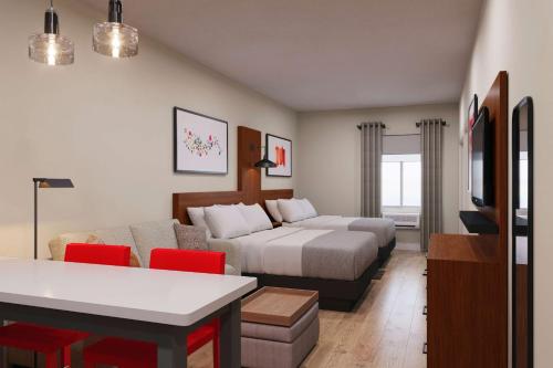 a hotel room with a bed and a couch at Hawthorn Extended Stay by Wyndham Mount Laurel Moorestown in Mount Laurel