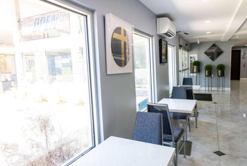 a dining room with tables and chairs and a window at Baymont by Wyndham College Park Atlanta Airport South in Atlanta