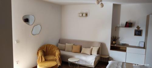 a living room with a couch and a chair at Riviera Rooms and Apartments in Rab