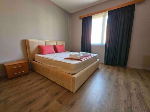 - une chambre avec un lit et 2 oreillers rouges dans l'établissement Terrace Flat in Heart of Tirana, à Tirana