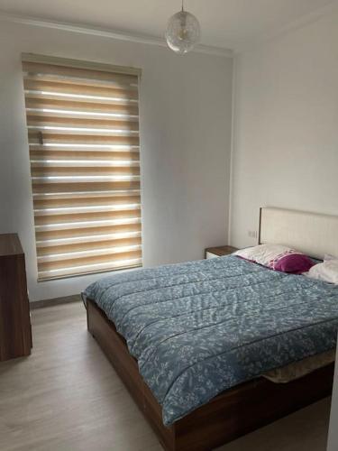 um quarto com uma cama grande e uma janela em Appartement De Luxe à Taghazout em Agadir
